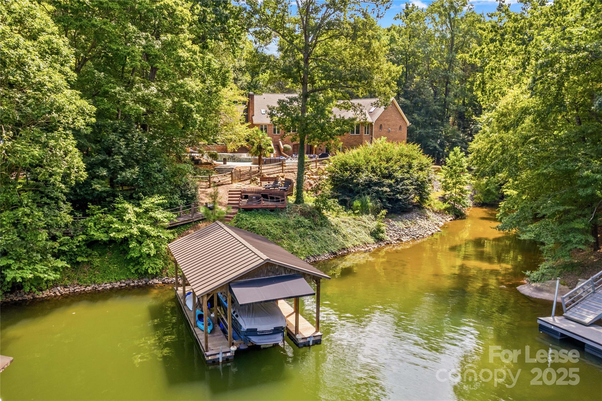 709 Normandy Road Mooresville, NC 28117 - Photo 6 of 46 a small pool with lawn chairs and large trees