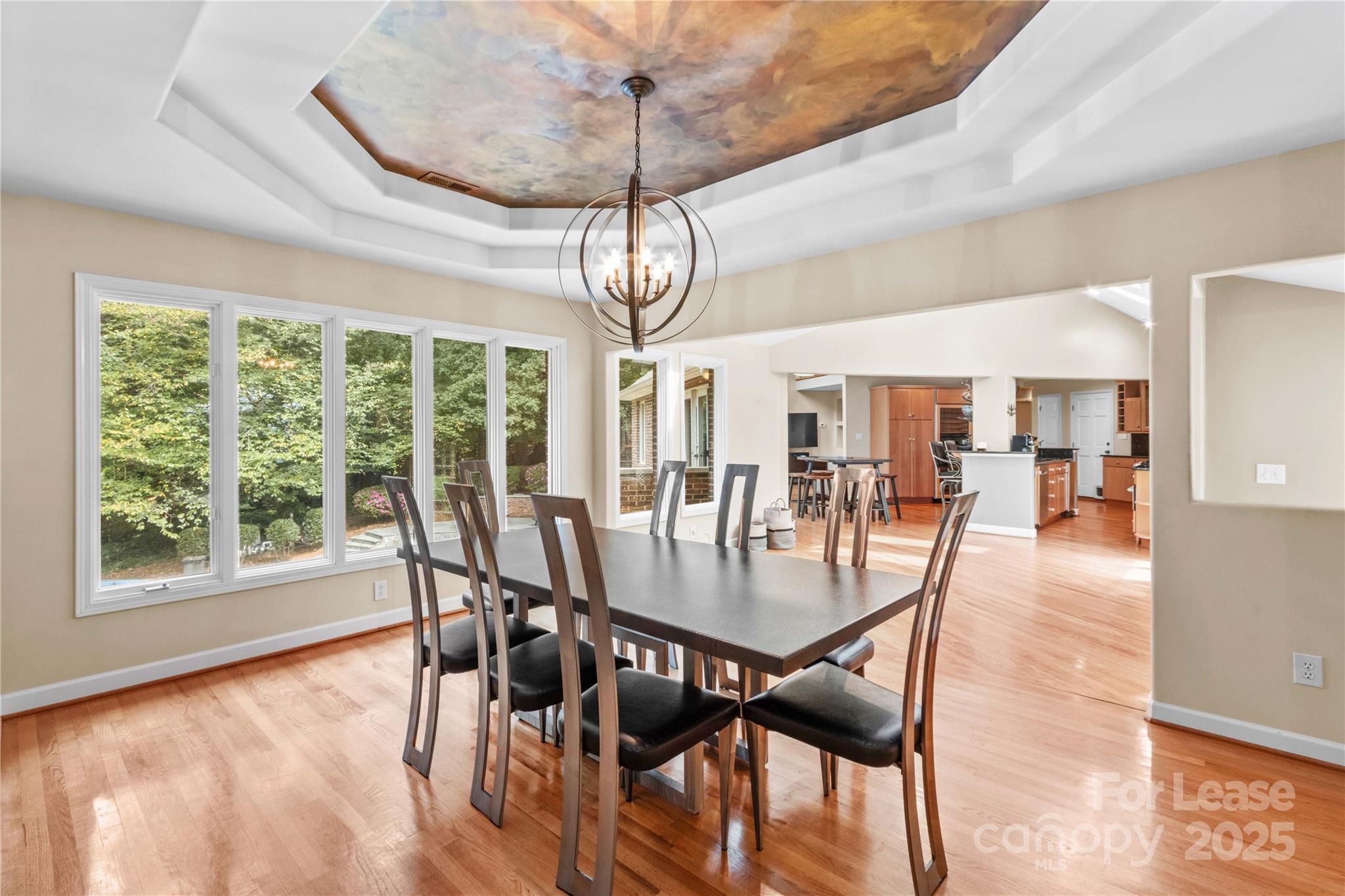 709 Normandy Road Mooresville, NC 28117 - Photo 10 of 46 a view of a dining room with furniture wooden floor and chandelier