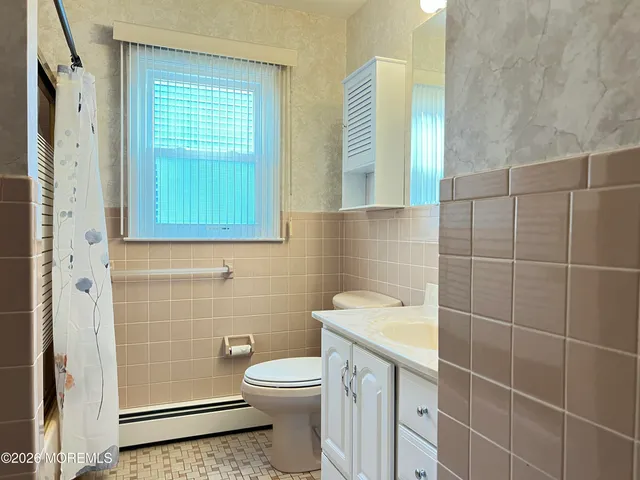 a bathroom with a toilet a sink and a shower