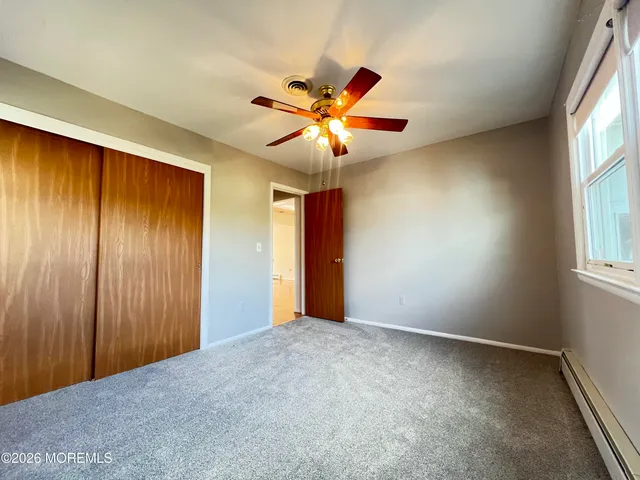 a view of a livingroom with a ceiling fan and window