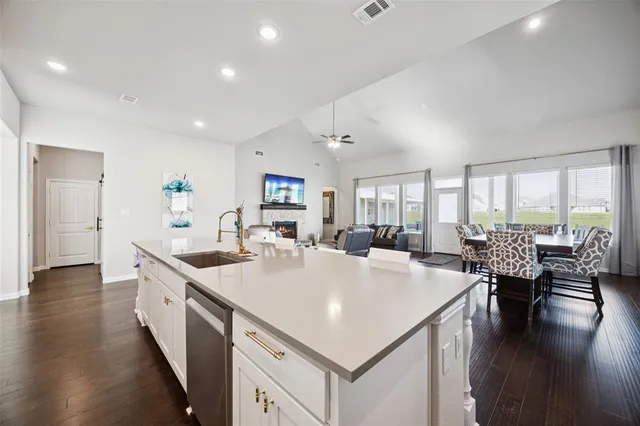 a large white kitchen with a large window