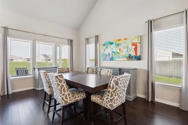 a dining room with furniture wooden floor and a rug