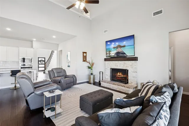 a living room with furniture a fireplace and a chandelier