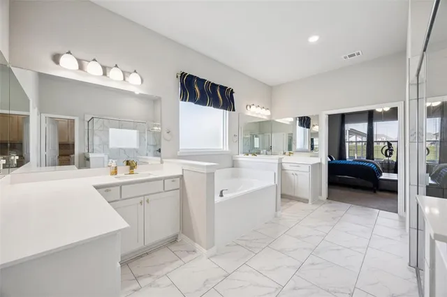 a kitchen with white cabinets and sink