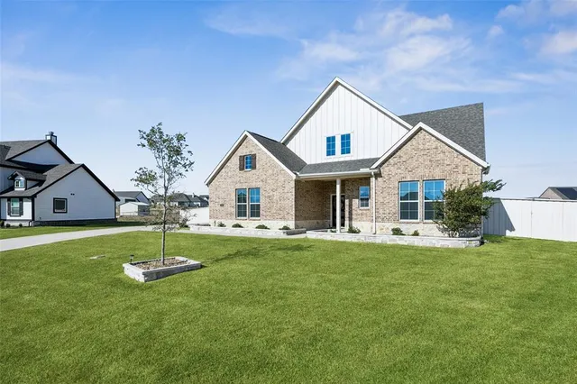 a view of a house with a yard and porch