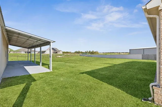 a view of a garden with lawn chairs
