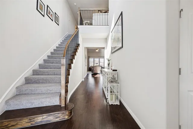 a view of entryway and hall with wooden floor