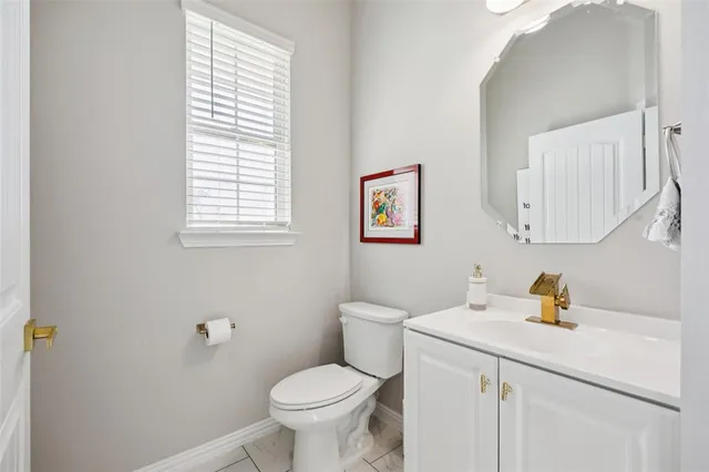 a bathroom with a sink toilet and a window