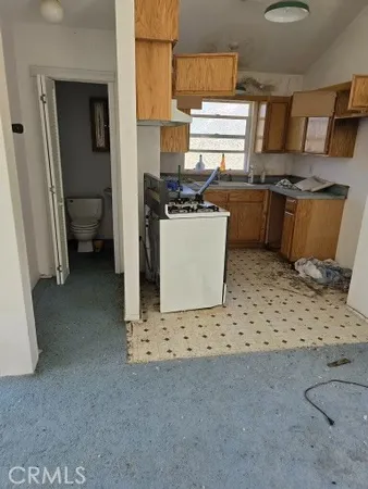 a kitchen with stainless steel appliances a stove a sink and a refrigerator