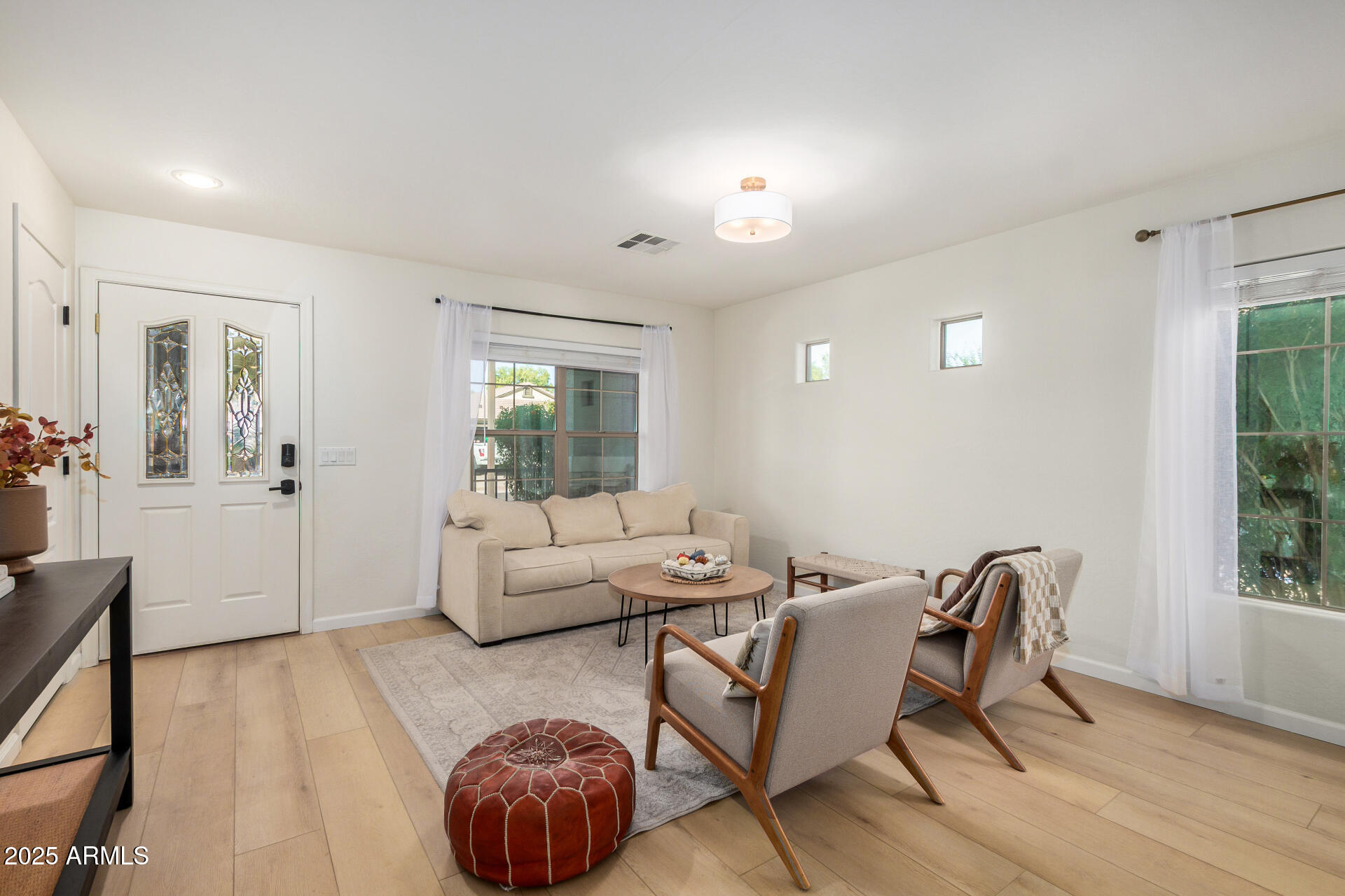3433 East Hopkins Road Gilbert, AZ 85295 - Photo 12 of 38 a living room with furniture and a large window