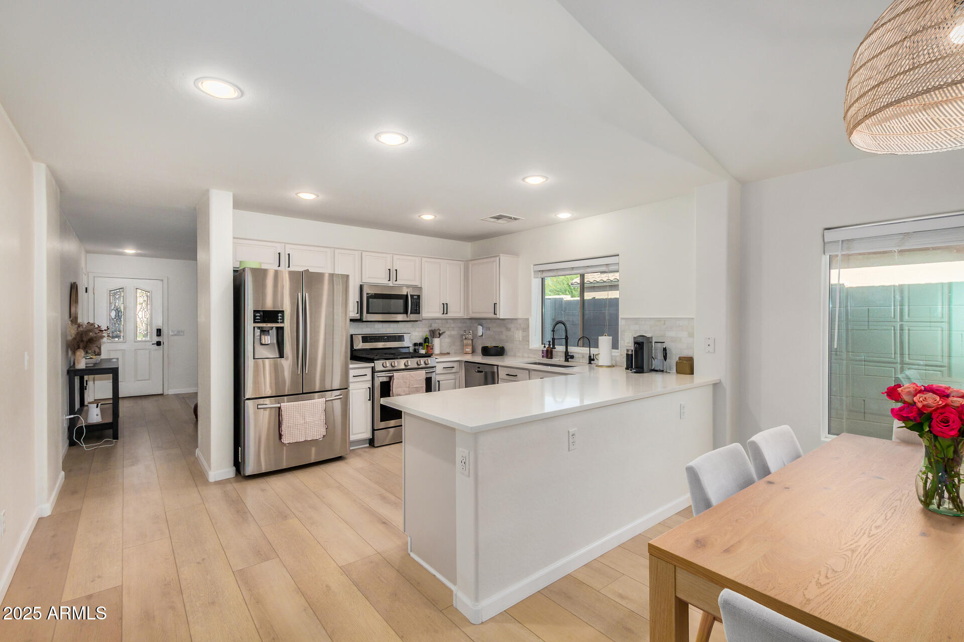 3433 East Hopkins Road Gilbert, AZ 85295 - Photo 17 of 38 a kitchen with stainless steel appliances kitchen island sink stove refrigerator and cabinets