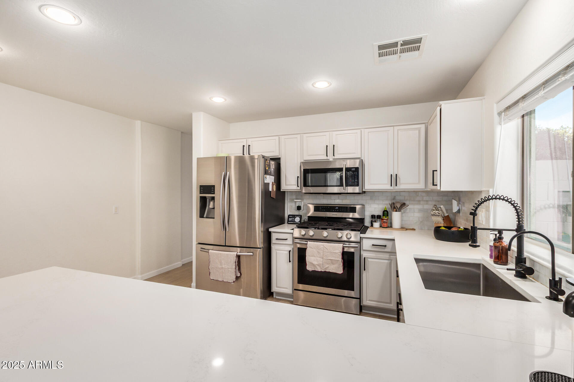 3433 East Hopkins Road Gilbert, AZ 85295 - Photo 20 of 38 a kitchen with stainless steel appliances granite countertop a refrigerator sink and stove