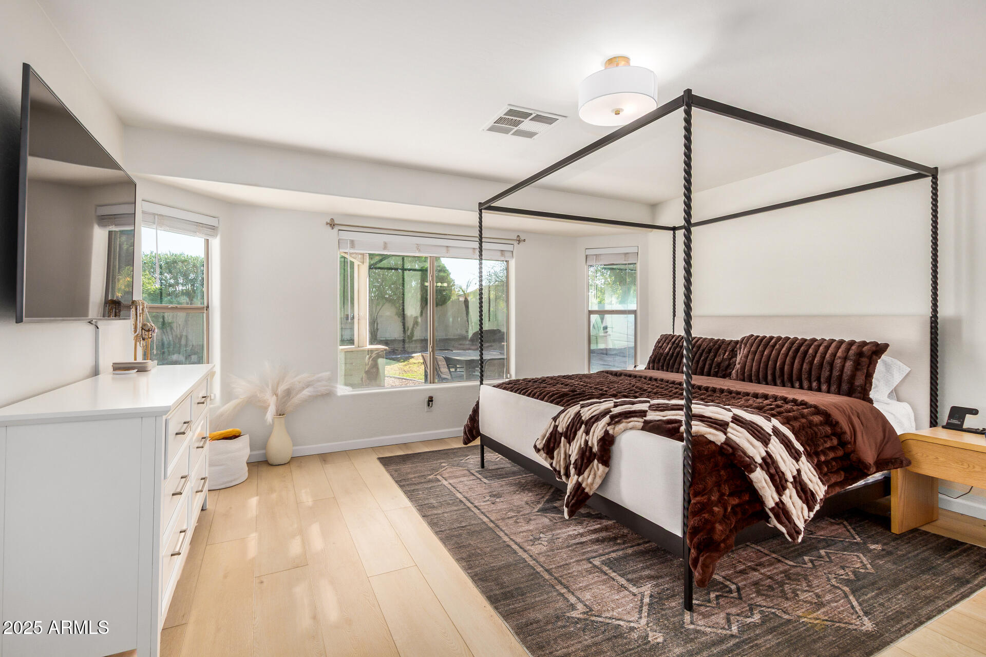 3433 East Hopkins Road Gilbert, AZ 85295 - Photo 21 of 38 a bedroom with a large bed and a chandelier