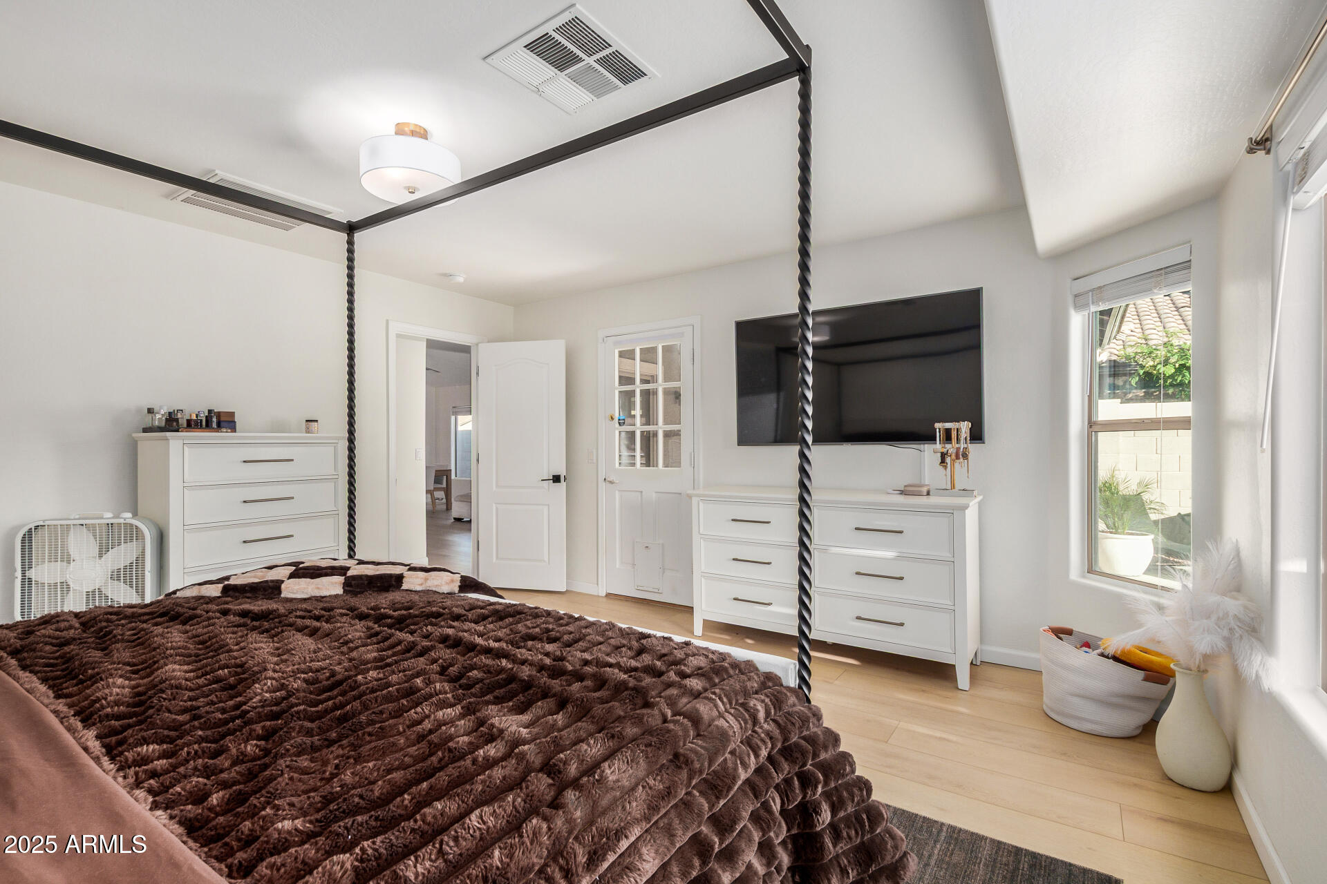 3433 East Hopkins Road Gilbert, AZ 85295 - Photo 23 of 38 a bedroom with a bed and wooden floor