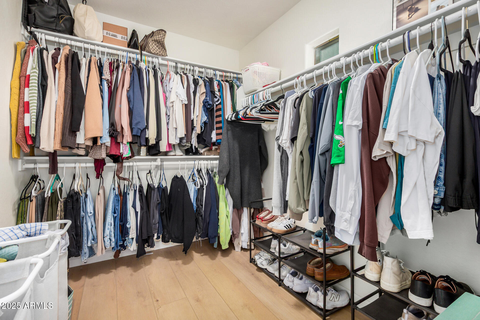 3433 East Hopkins Road Gilbert, AZ 85295 - Photo 26 of 38 a view of walk in closet with clothes and shoes