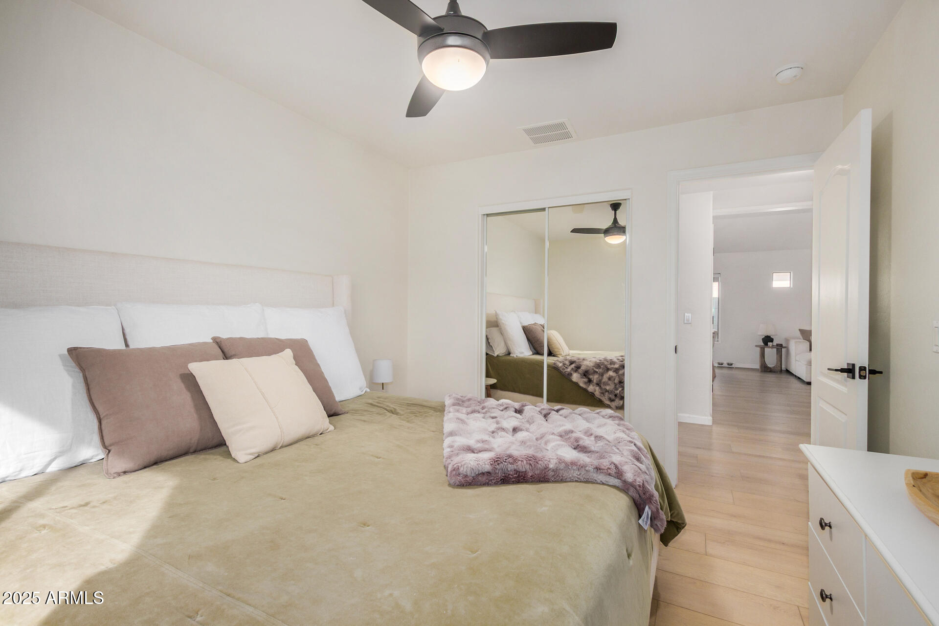 3433 East Hopkins Road Gilbert, AZ 85295 - Photo 28 of 38 a bedroom with a large bed and a chandelier