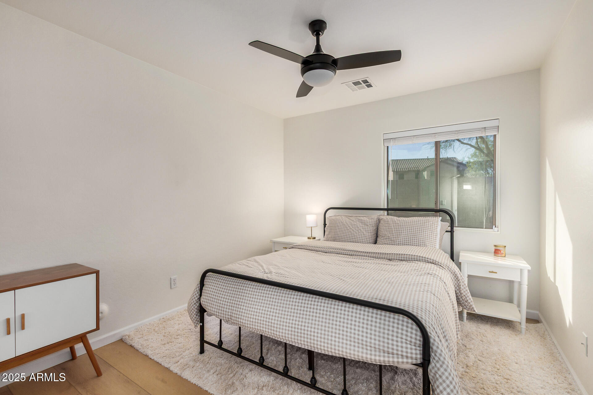 3433 East Hopkins Road Gilbert, AZ 85295 - Photo 29 of 38 a bedroom with a large bed and a chandelier