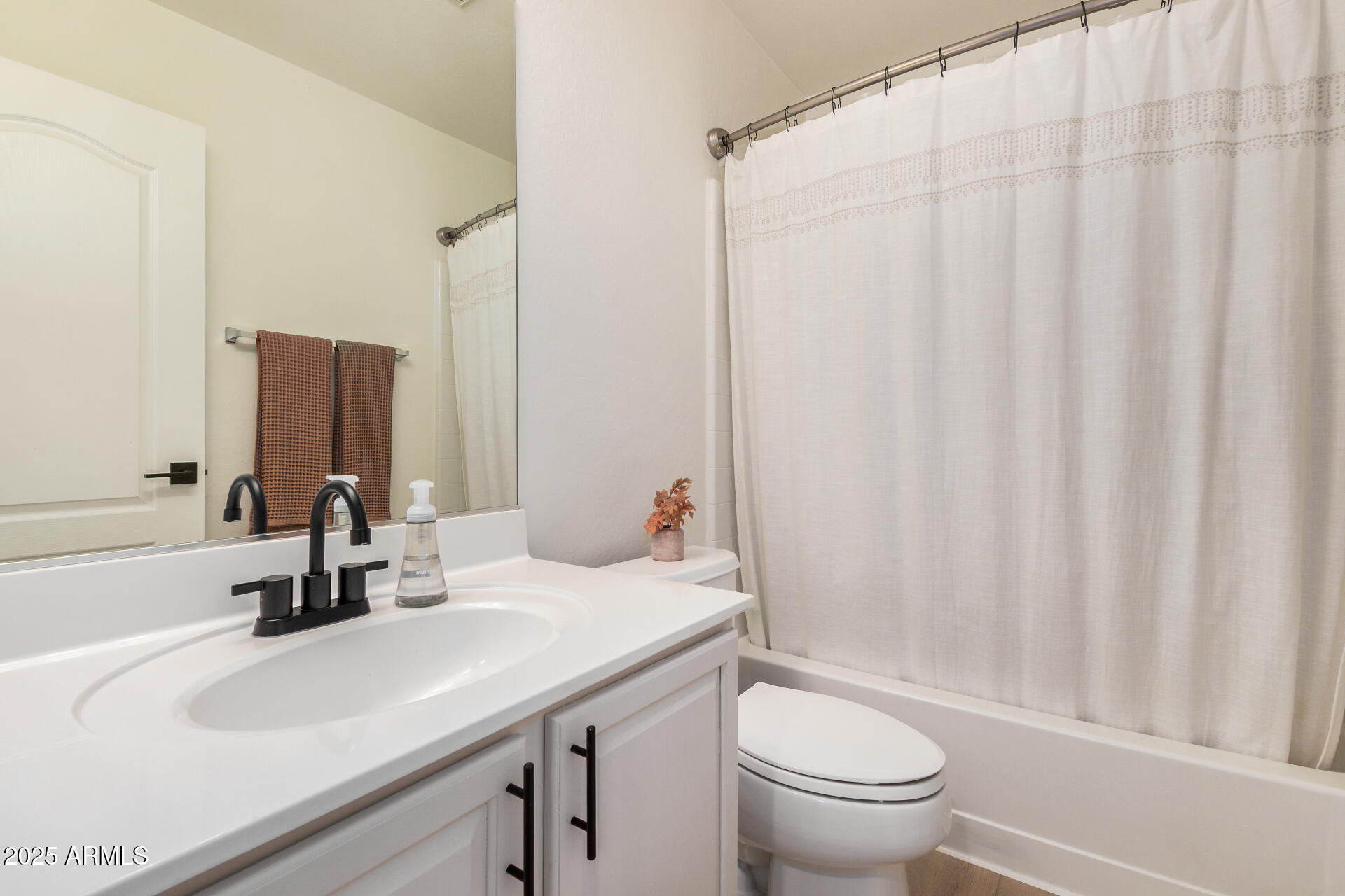 3433 East Hopkins Road Gilbert, AZ 85295 - Photo 31 of 38 a bathroom with a sink a toilet and a mirror