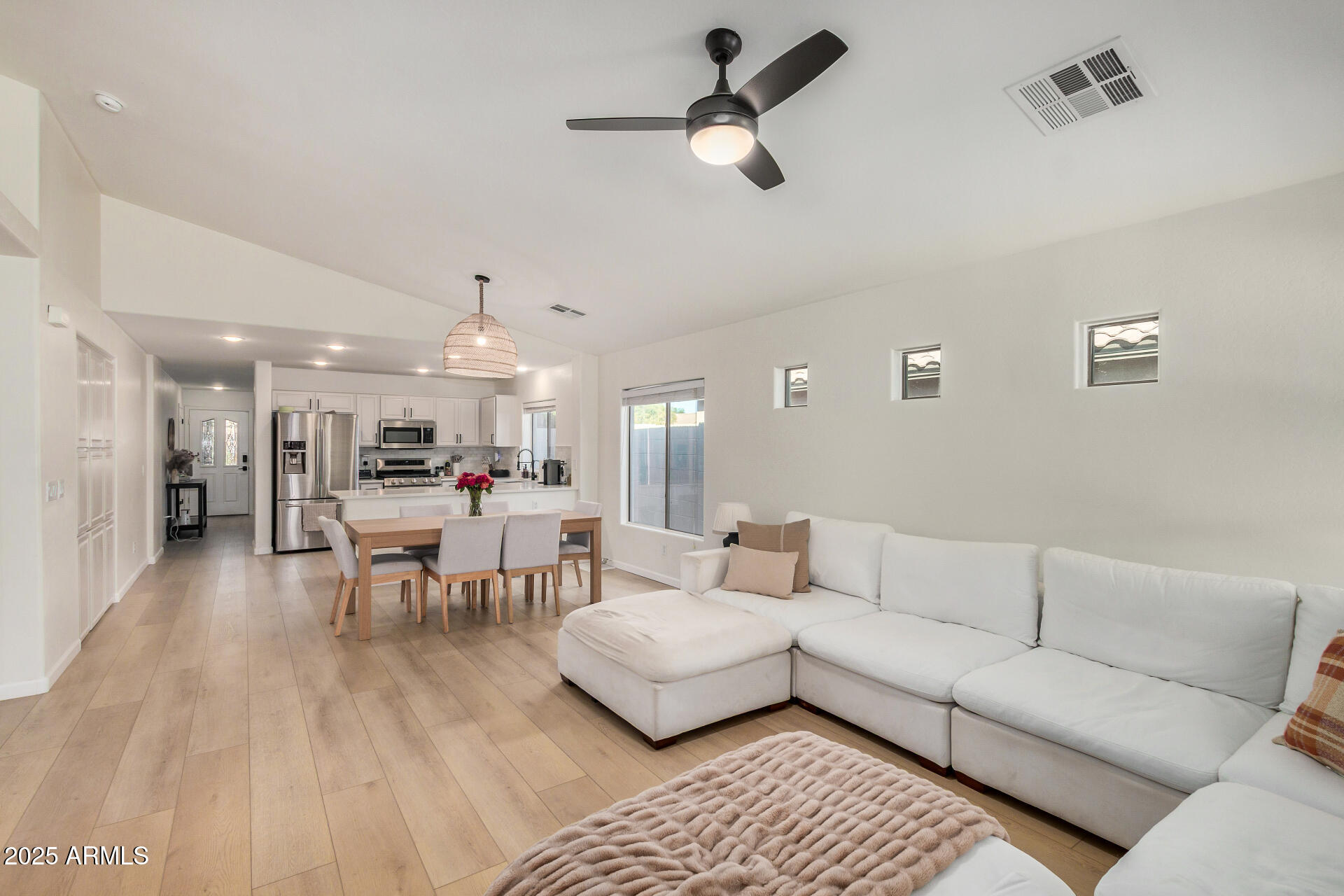 3433 East Hopkins Road Gilbert, AZ 85295 - Photo 5 of 38 a living room with furniture and a view of kitchen