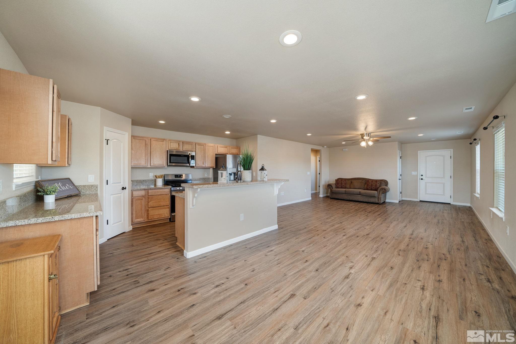2513 Ladera Fallon, NV 89406 - Photo 11 of 30 a view of kitchen with kitchen island wooden floors appliances and cabinets