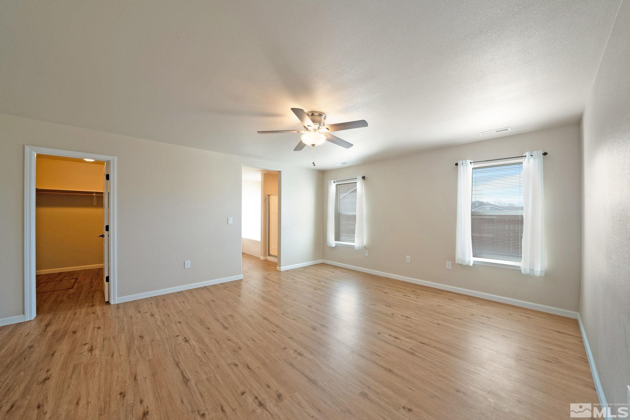 2513 Ladera Fallon, NV 89406 - Photo 16 of 30 a view of an empty room with a window and wooden floor