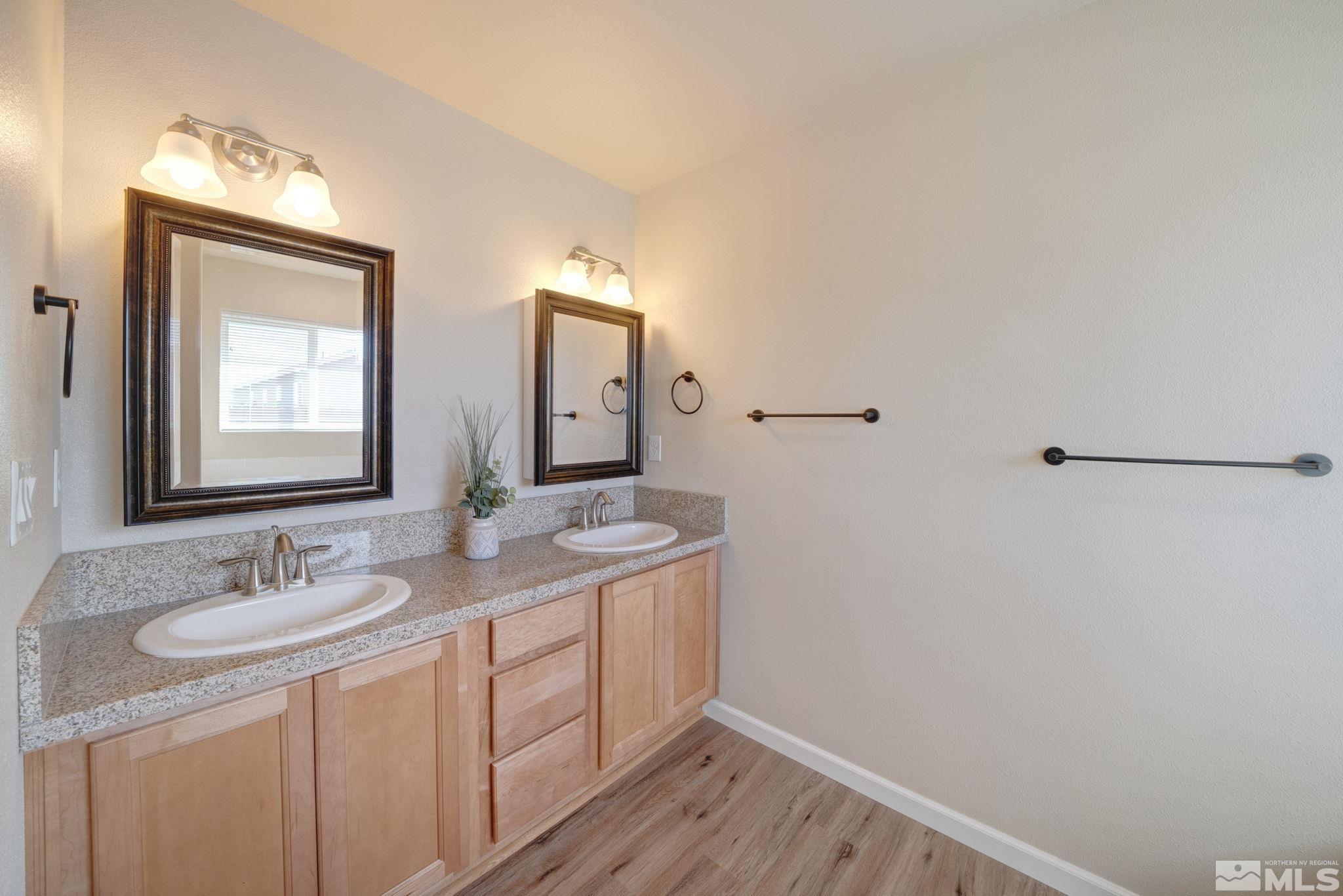 2513 Ladera Fallon, NV 89406 - Photo 18 of 30 a bathroom with a granite countertop sink mirror and vanity