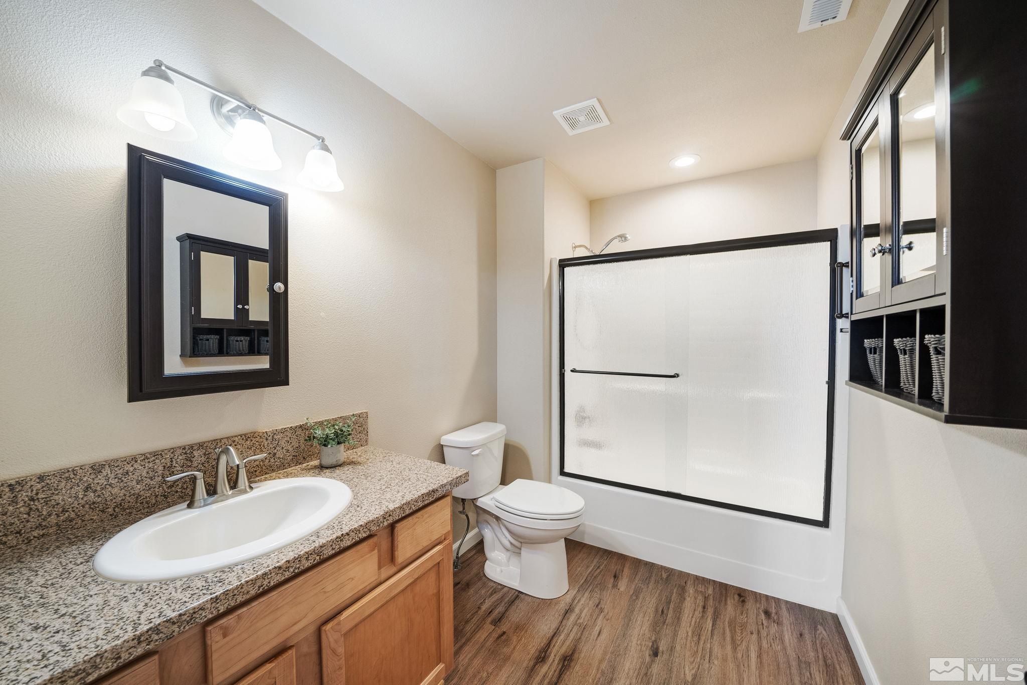2513 Ladera Fallon, NV 89406 - Photo 21 of 30 a bathroom with a granite countertop sink mirror vanity and toilet