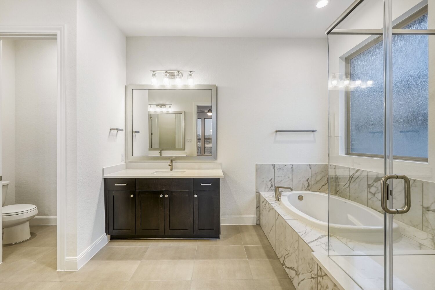 222 Prickly Poppy Loop Kyle, TX 78640 - Photo 6 of 11 a spacious bathroom with a tub sink and mirror