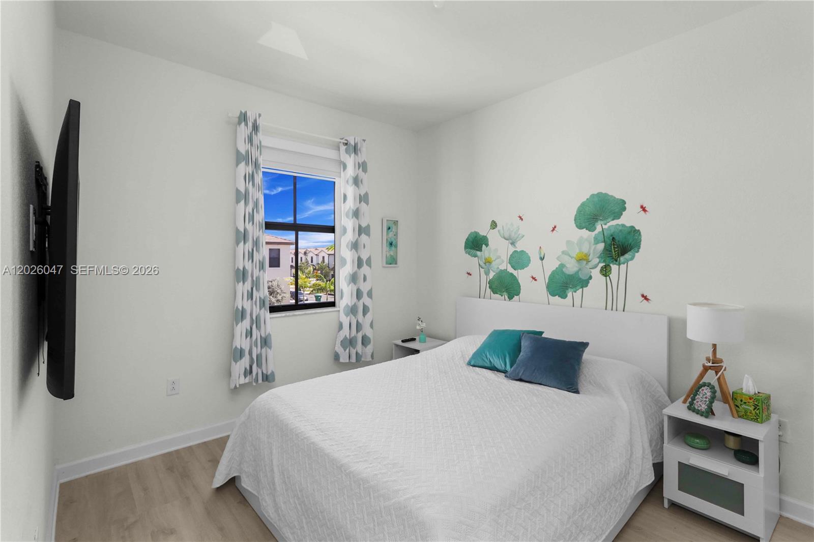 12862 Southwest 231st Street Miami, FL 33170 - Photo 26 of 30 a bedroom with a bed table and a lamp