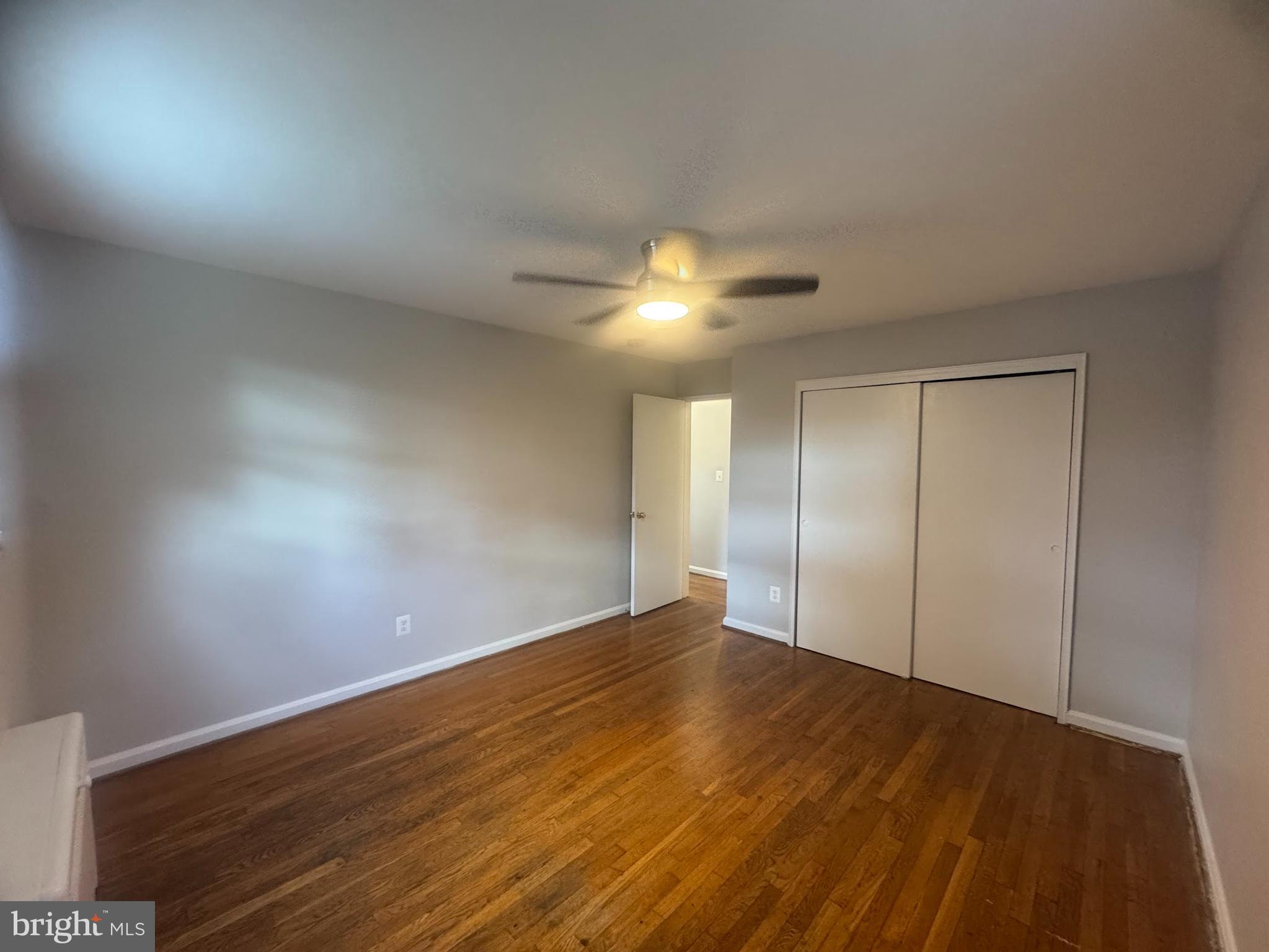 500 South Courthouse Road, Unit 9 Arlington, VA 22204 - Photo 14 of 18 a view of an empty room with wooden floor and a fan