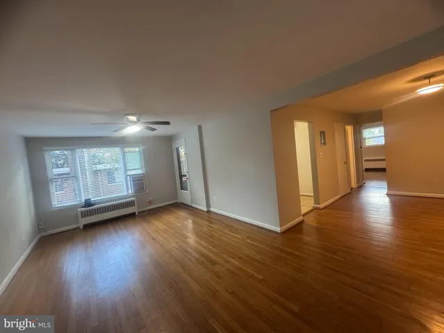 a view of a livingroom with wooden floor and window