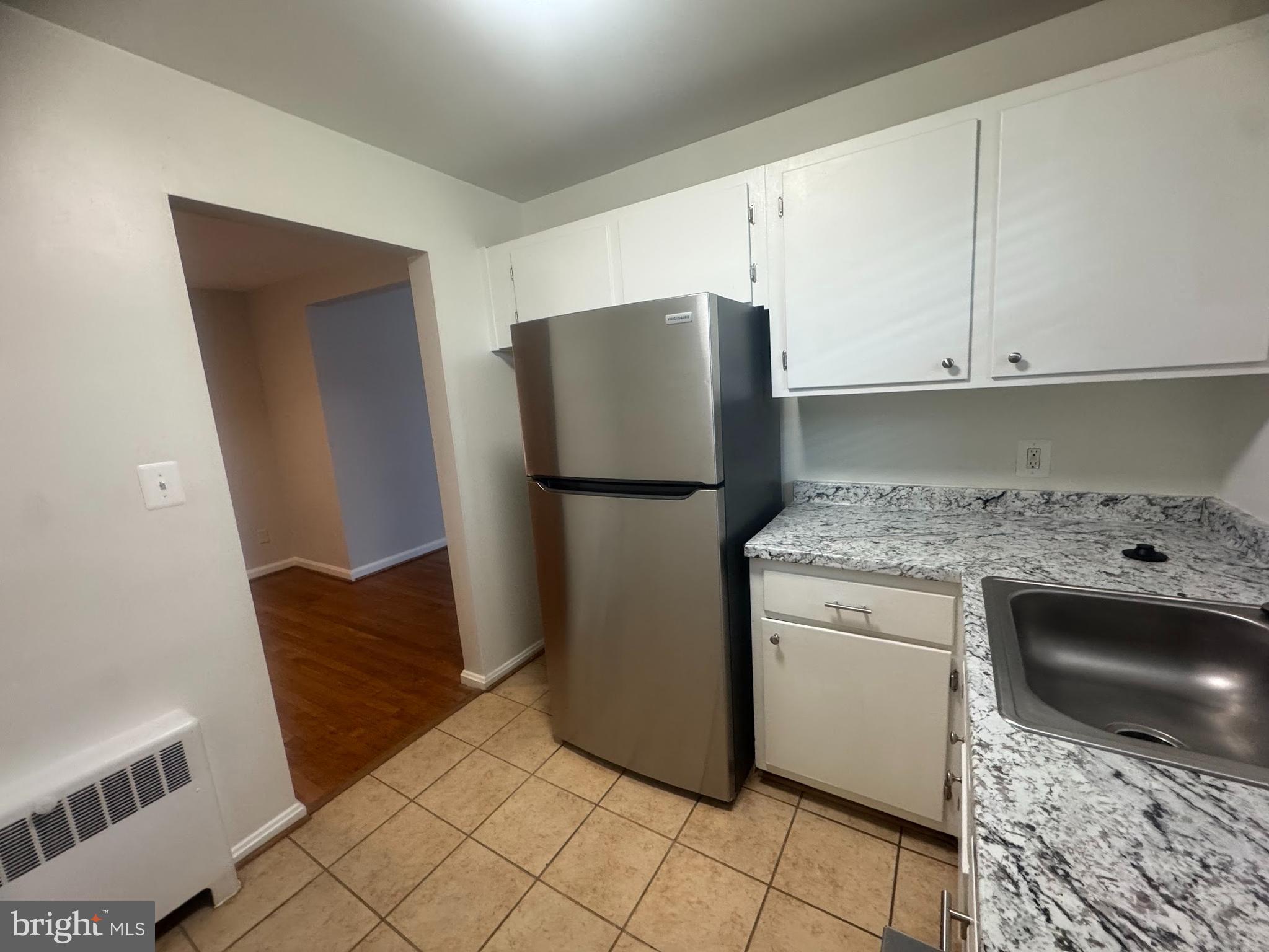 500 South Courthouse Road, Unit 9 Arlington, VA 22204 - Photo 7 of 18 a kitchen with a refrigerator and a stove top oven