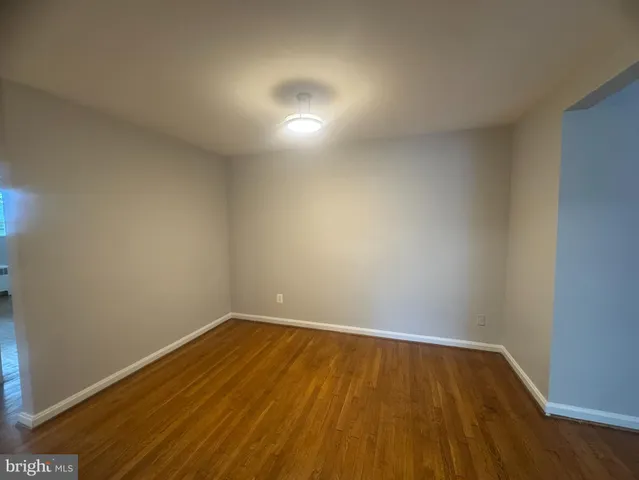 a view of room with wooden floor