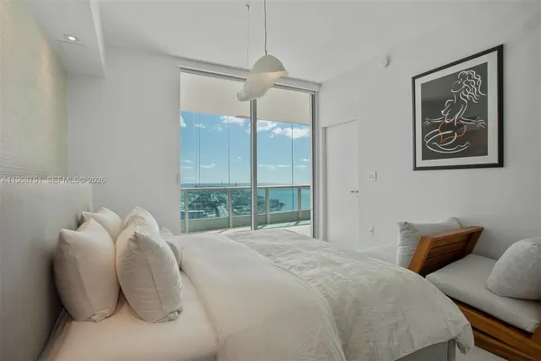 a bedroom with a bed and a painting on the wall