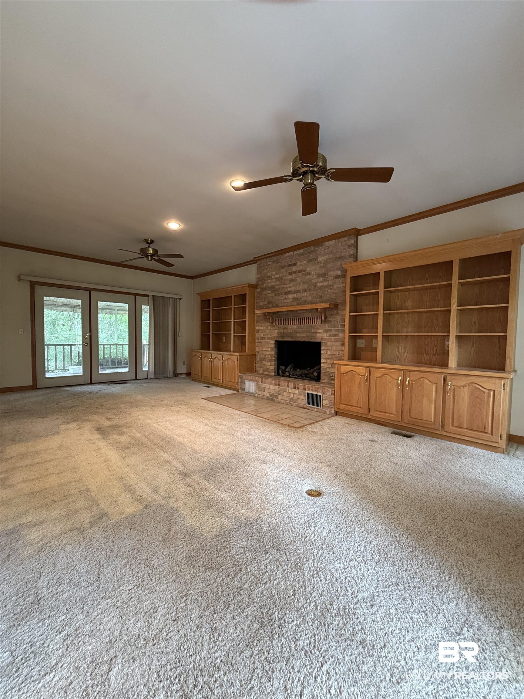 295 Norwood Road Monroeville, AL 36460 - Photo 2 of 32 Unfurnished living room with crown molding, ceiling fan, carpet, and a brick fireplace