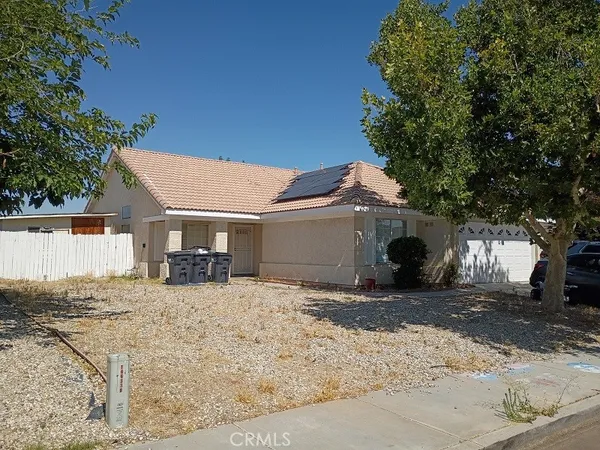 a view of a house with a yard and garage