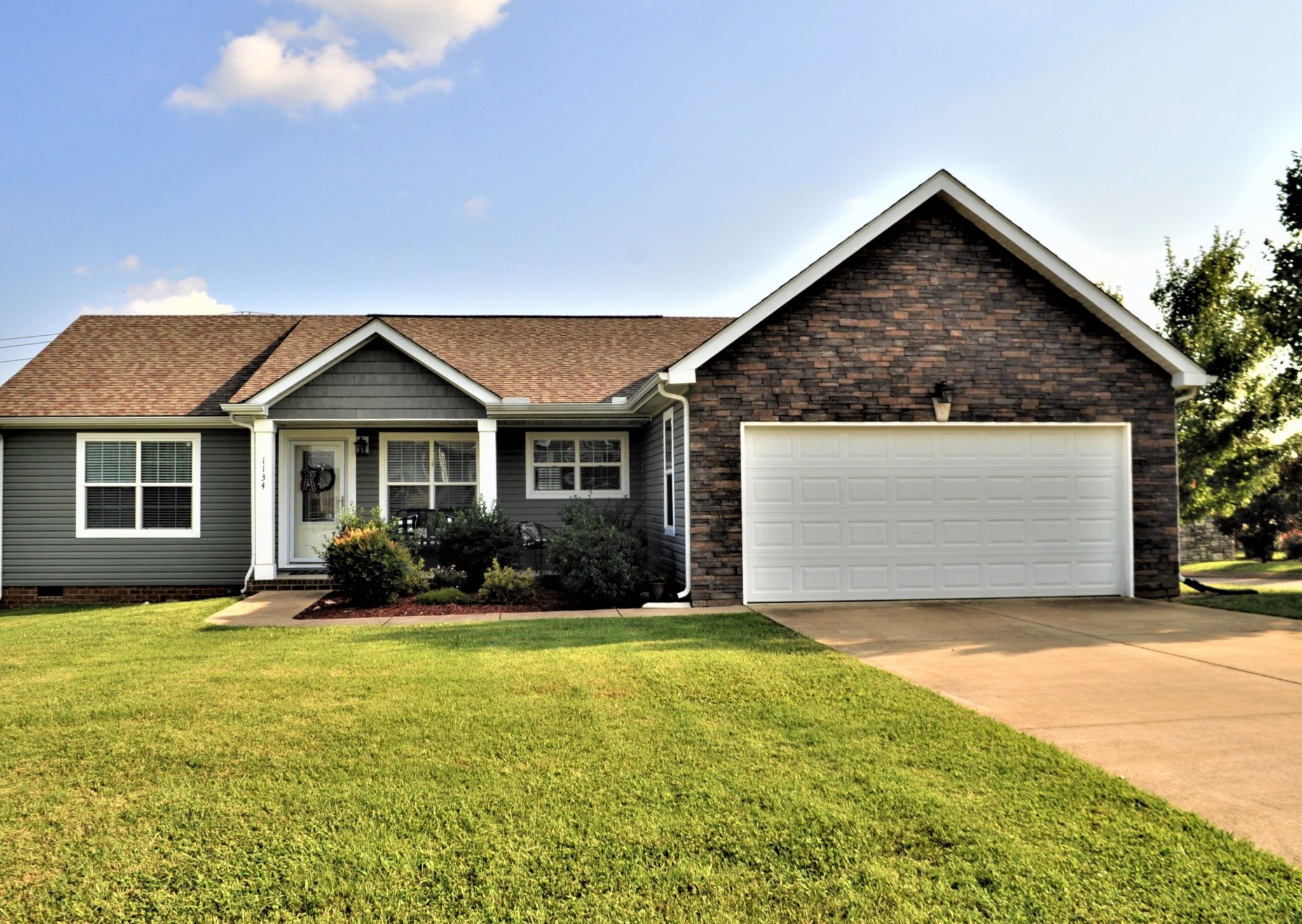 1134 Wrights Mill Road Spring Hill, TN 37174 - Photo 1 of 26 a front view of a house with yard and porch