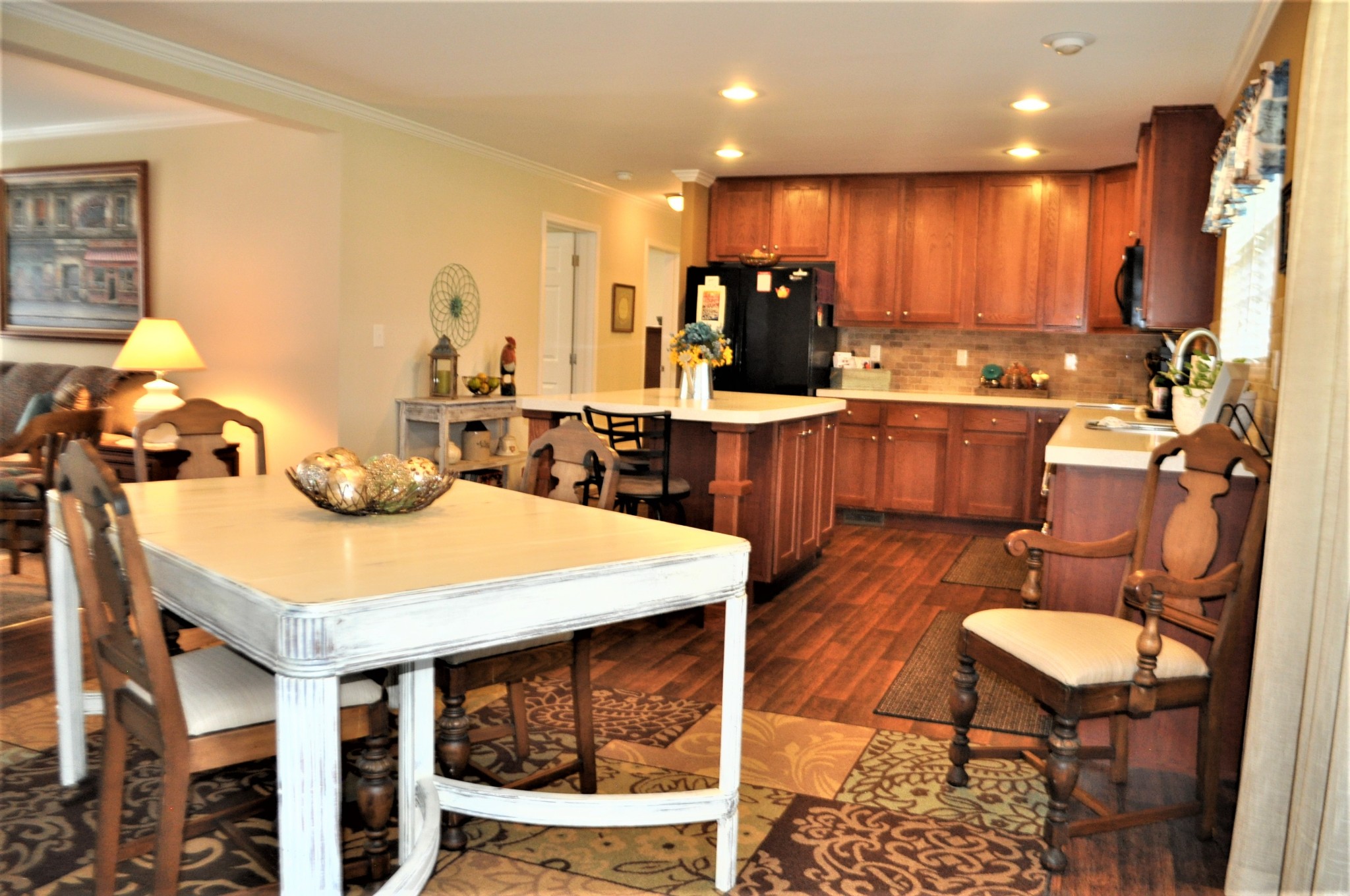 1134 Wrights Mill Road Spring Hill, TN 37174 - Photo 5 of 26 a kitchen with stainless steel appliances kitchen island granite countertop a table chairs and a refrigerator