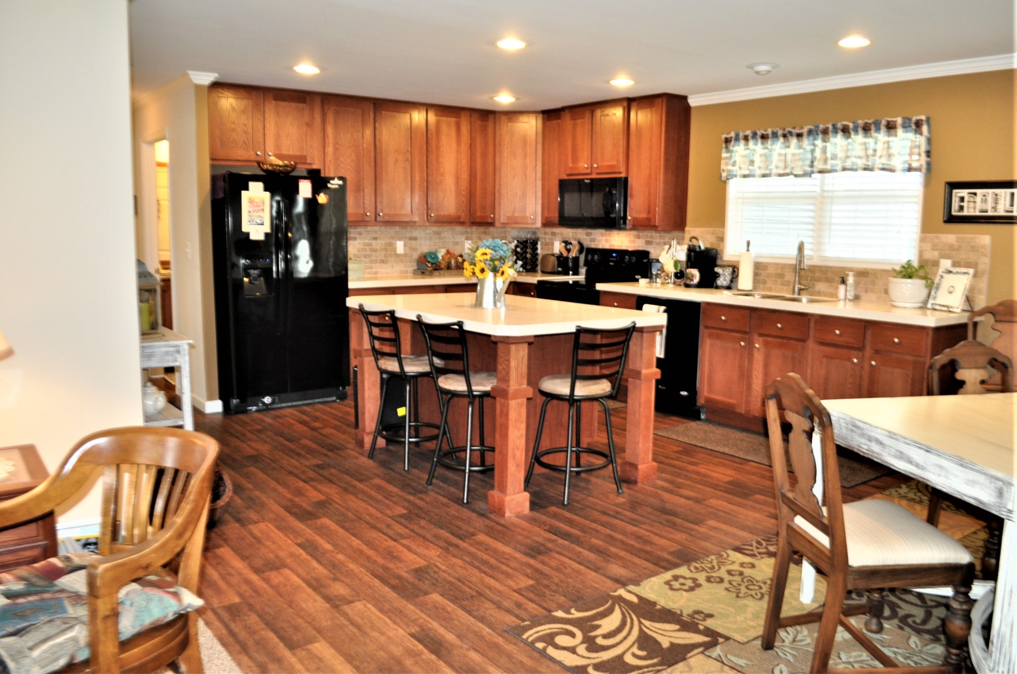 1134 Wrights Mill Road Spring Hill, TN 37174 - Photo 8 of 26 a kitchen with stainless steel appliances granite countertop a table chairs sink and cabinets