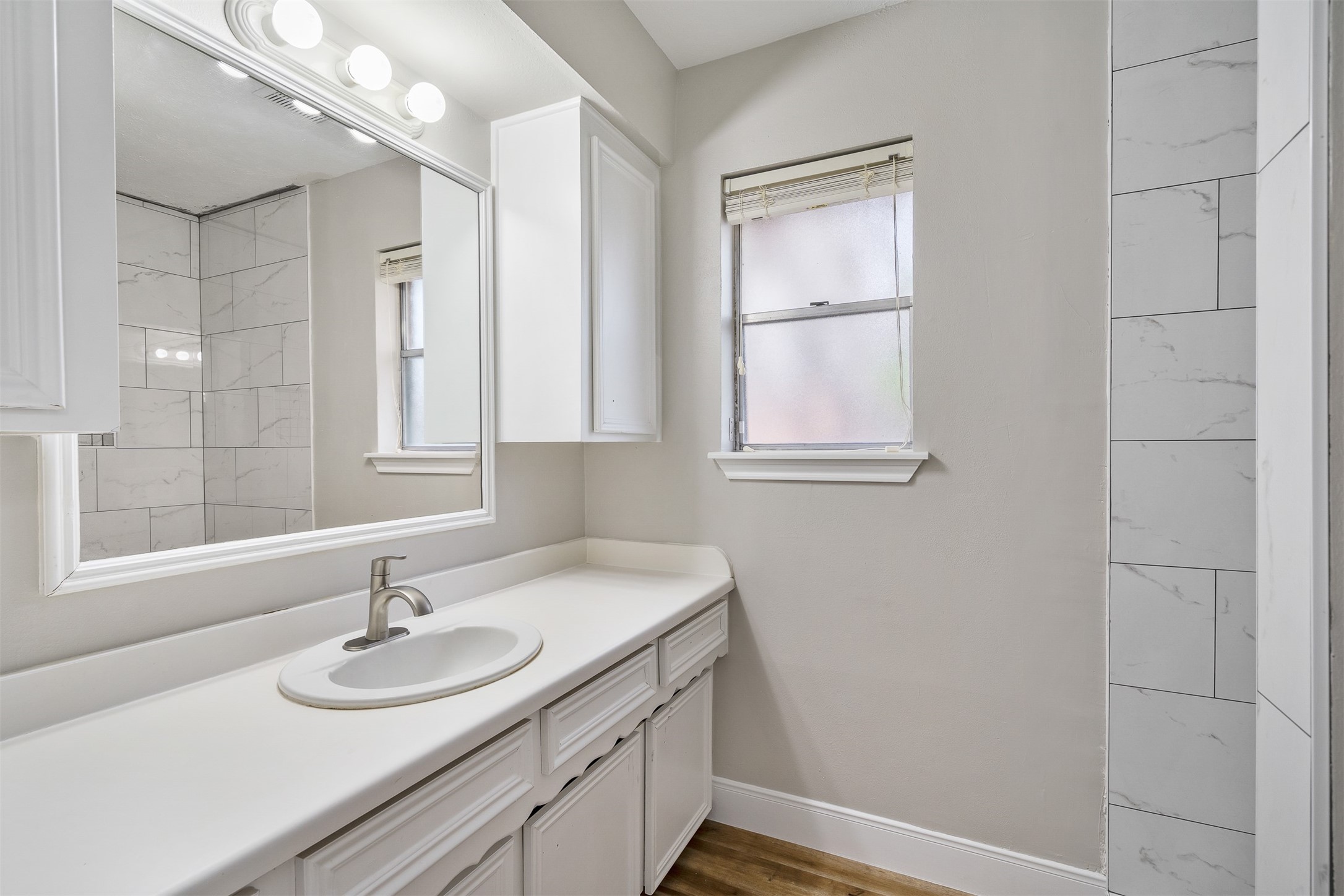 25519 Many Oak Drive Spring, TX 77380 - Photo 19 of 33 a bathroom with a sink double vanity and a mirror