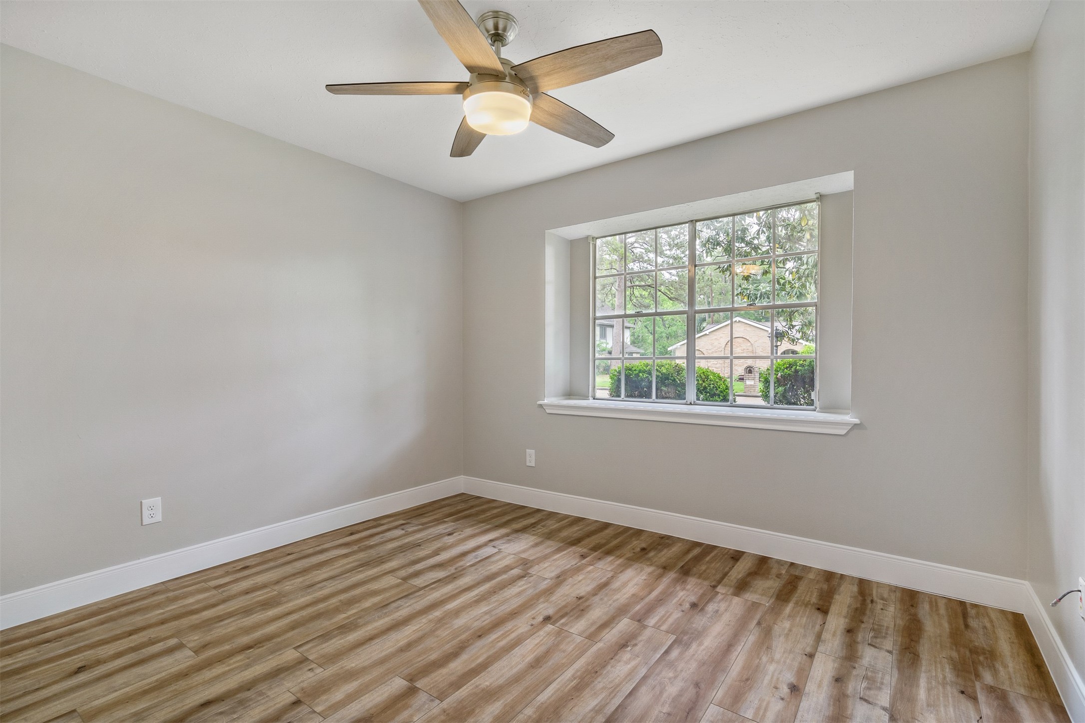 25519 Many Oak Drive Spring, TX 77380 - Photo 21 of 33 wooden floor in an empty room with a window