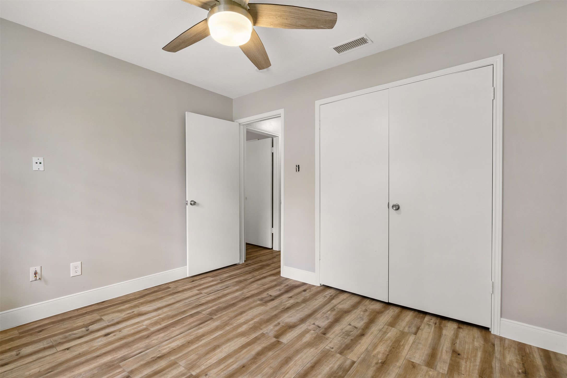 25519 Many Oak Drive Spring, TX 77380 - Photo 22 of 33 a view of an empty room with wooden floor and a ceiling fan