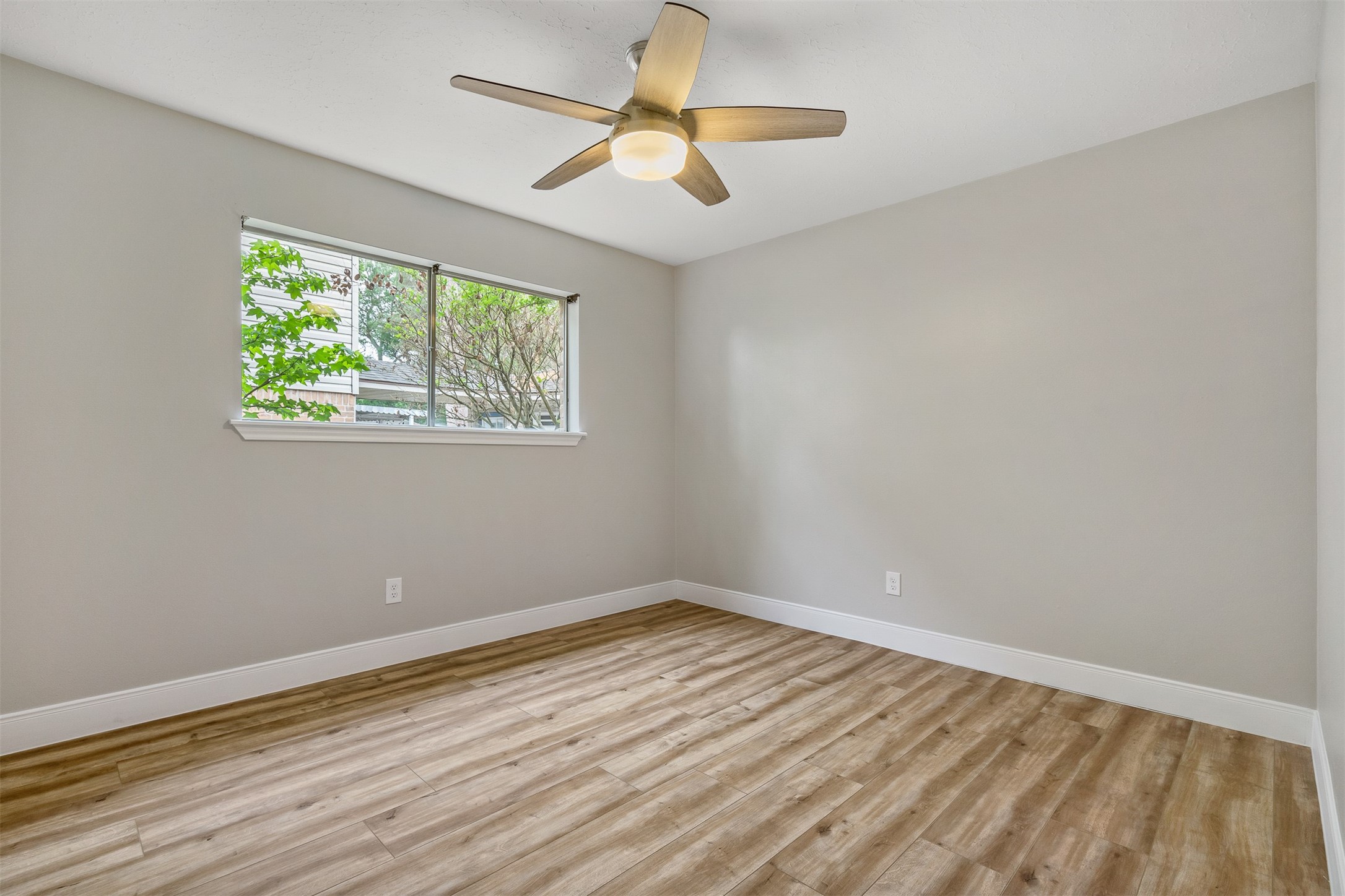 25519 Many Oak Drive Spring, TX 77380 - Photo 26 of 33 wooden floor in an empty room with a window