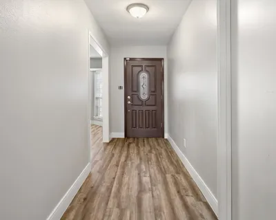 a view of a room with wooden floor