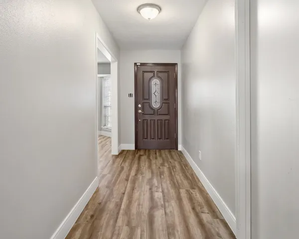 a view of a room with wooden floor