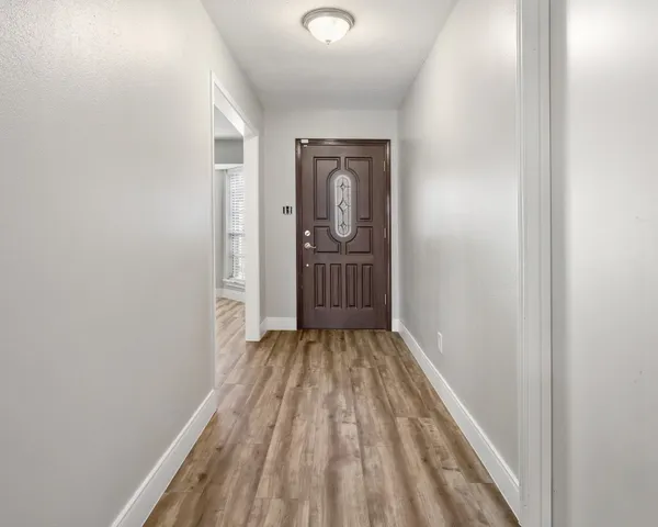a view of a room with wooden floor