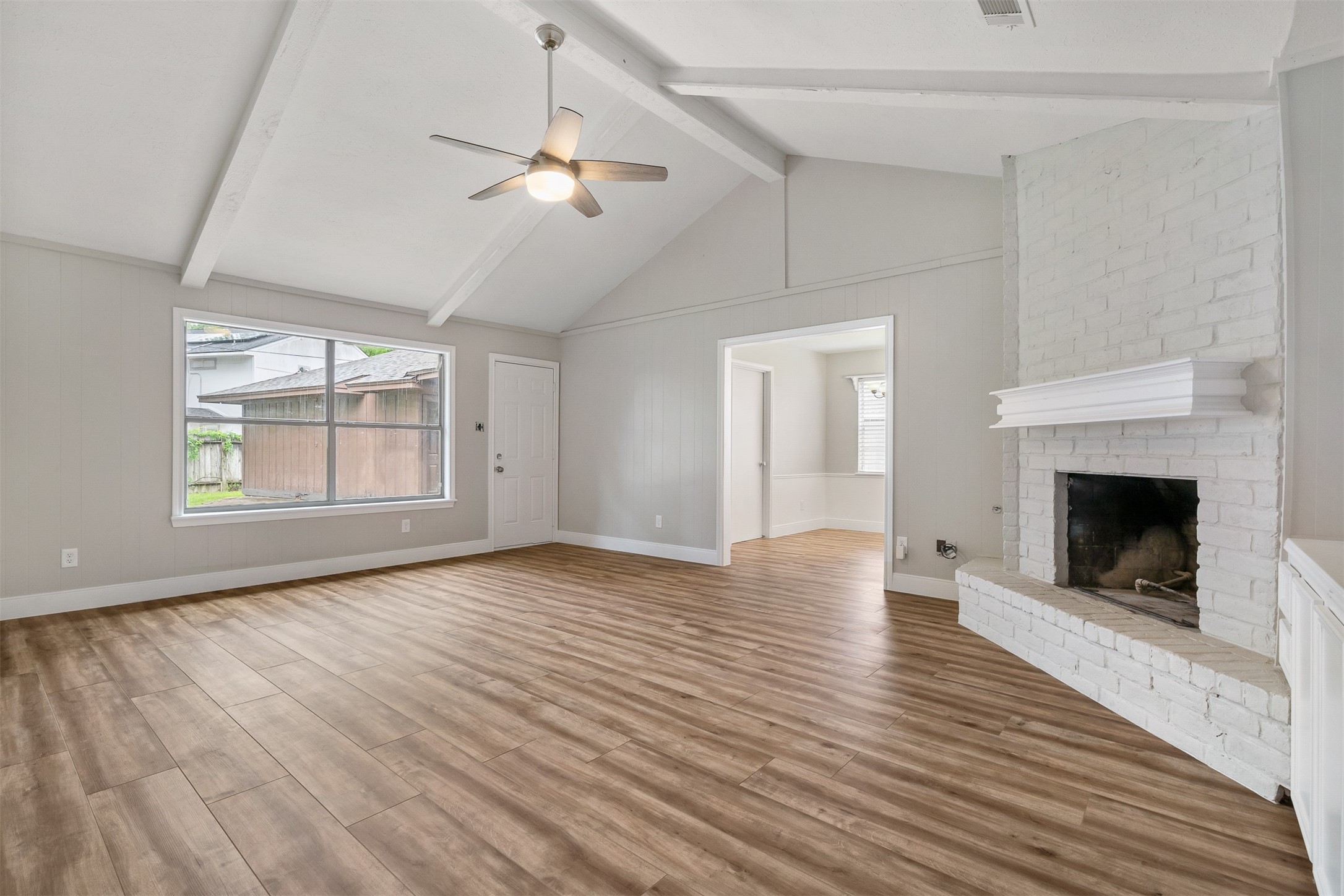 25519 Many Oak Drive Spring, TX 77380 - Photo 8 of 33 a view of an empty room with wooden floor fireplace and a window