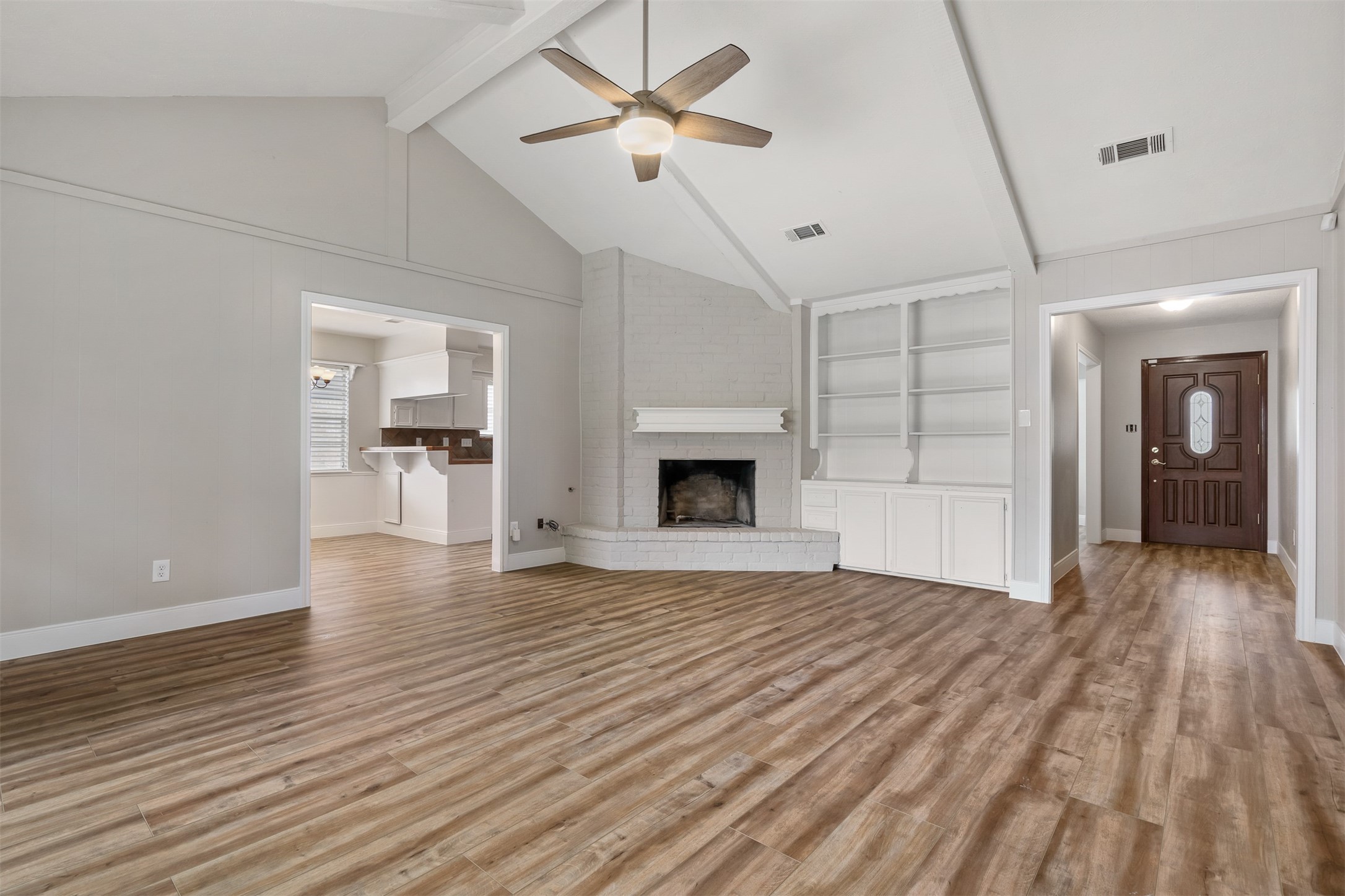 25519 Many Oak Drive Spring, TX 77380 - Photo 9 of 33 a view of empty room with wooden floor and fireplace