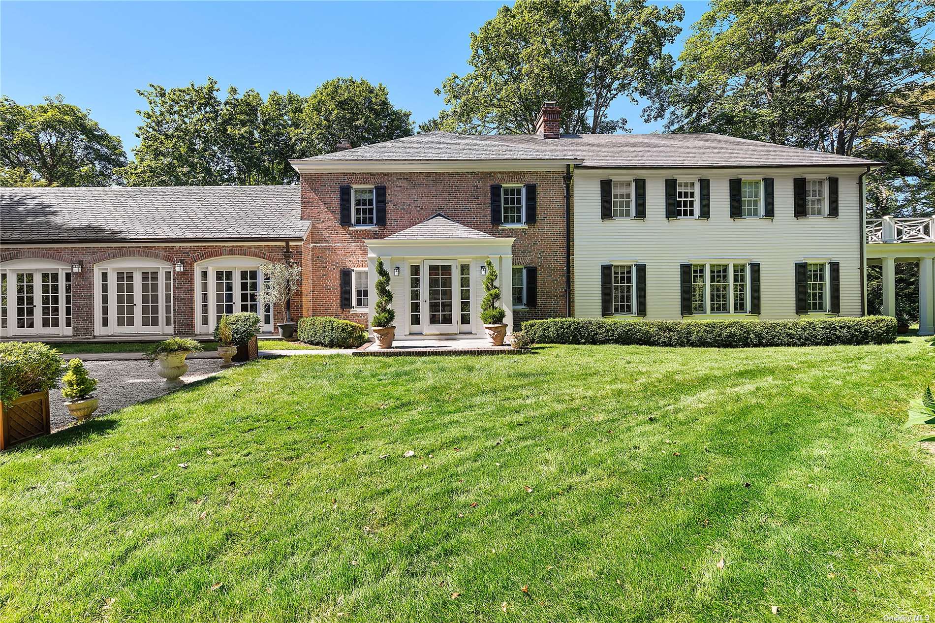 191 Rose Hill Road Water Mill, NY 11976 - Photo 1 of 22 a front view of a house with a yard