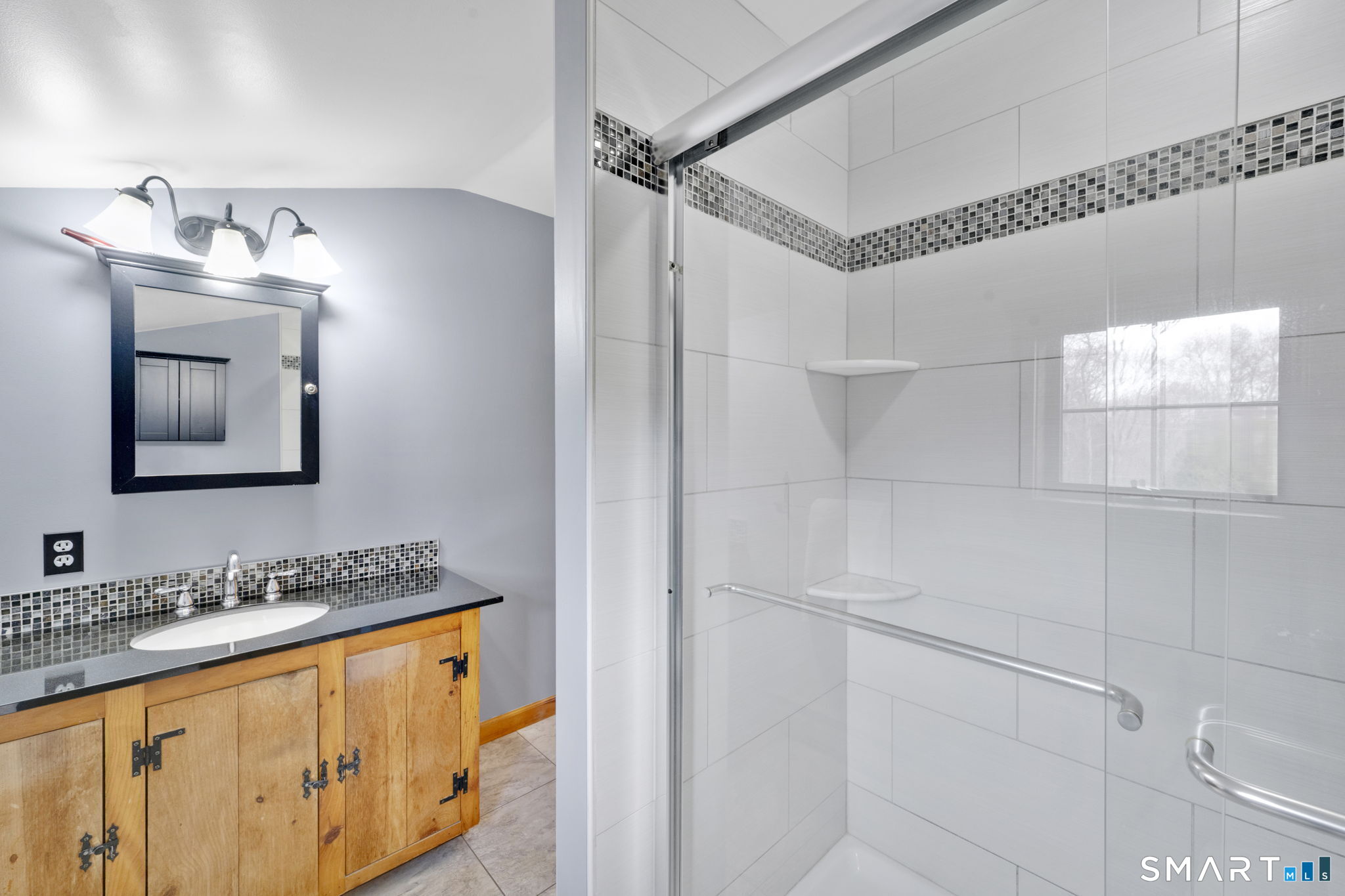 260 West Street Hebron, CT 06248 - Photo 22 of 40 a bathroom with a granite countertop sink mirror and a shower